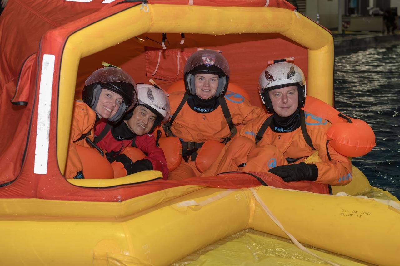 jsc2023e040866 (June 7, 2024) --- SpaceX Crew-10 members (from left) Pilot Nichole Ayers of NASA, Mission Specialist Takuya Onishi of JAXA (Japan Aerospace Exploration Agency), Commander Anne McClain of NASA, and Mission Specialist Kirill Peskov of Roscosmos participate in water survival training in the Neutral Buoyancy Laboratory at NASA's Johnson Space Center.