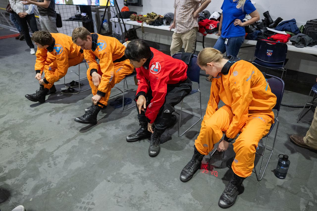 jsc2023e040984 (June 7, 2024) --- SpaceX Crew-10 members (from left) Commander Anne McClain of NASA, Mission Specialists Kirill Peskov of Roscosmos and Takuya Onishi of JAXA (Japan Aerospace Exploration Agency), and Pilot Nichole Ayers of NASA suit up for water survival training in the Neutral Buoyancy Laboratory at NASA's Johnson Space Center.