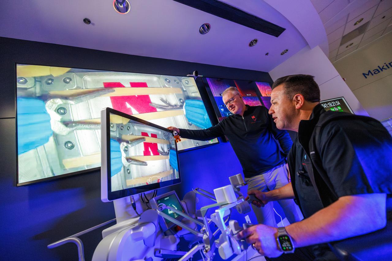jsc2024e041212 (2/10/2024) --- Professor Shane Farritor (left) watches as Dr. Michael Jobst remotely operates a surgical robot aboard the International Space Station using controls at the Virtual Incision offices in Lincoln, Nebraska. Robotic Surgery Tech Demo tests techniques for performing robotic surgery in microgravity using a miniature surgical robot that can be remotely controlled or teleoperated from Earth. Results from this investigation could support the development of robotic systems to perform these procedures. Miniaturization and the ability to remotely control robots may help to make surgery available anywhere and anytime. Image courtesy of the University of Nebraska-Lincoln.