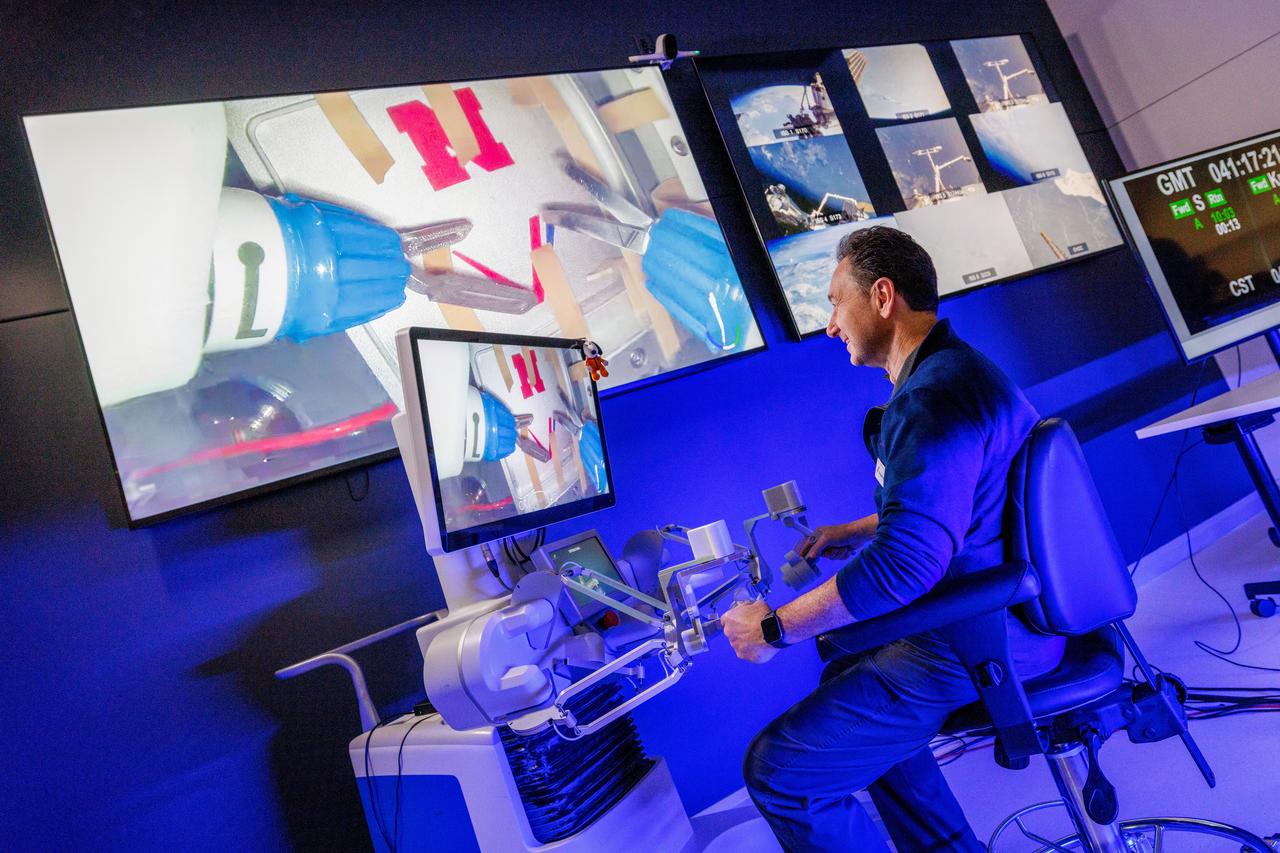 jsc2024e041215 (2/10/2024) --- Dr. Dmitry Oleynikov remotely operates a surgical robot aboard the International Space Station using controls at the Virtual Incision offices in Lincoln, Nebraska. Robotic Surgery Tech Demo tests techniques for performing a simulated surgical procedure in microgravity using a miniature surgical robot that can be remotely controlled or teleoperated from Earth. Results from this investigation could support the development of robotic systems to perform these procedures. Miniaturization and the ability to remotely control robots may help to make surgery available anywhere and anytime. Image courtesy of the University of Nebraska-Lincoln.