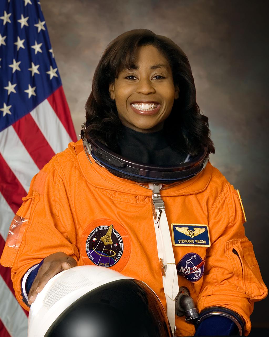 jsc2024e044936 (July 9, 2007) --- NASA astronaut Stephanie Wilson poses for a photo in a studio at NASA’s Johnson Space Center in Houston, Texas. Wilson will serve as a mission specialist for NASA’s SpaceX Crew-9 mission to the International Space Station, her fourth trip to space.