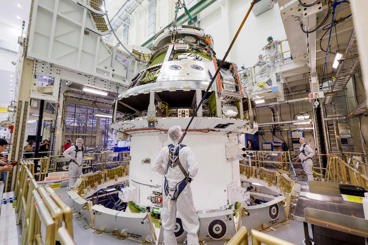 The Artemis II Orion spacecraft is lifted from the Final Assembly and Testing (FAST) Cell and placed in the west altitude chamber inside the Operations and Checkout Building at NASA’S Kennedy Space Center in Florida on June 28, 2024. Inside the altitude chamber, the spacecraft underwent a series of tests simulating deep space vacuum conditions. Photo Credit: NASA / Rad Sinyak 