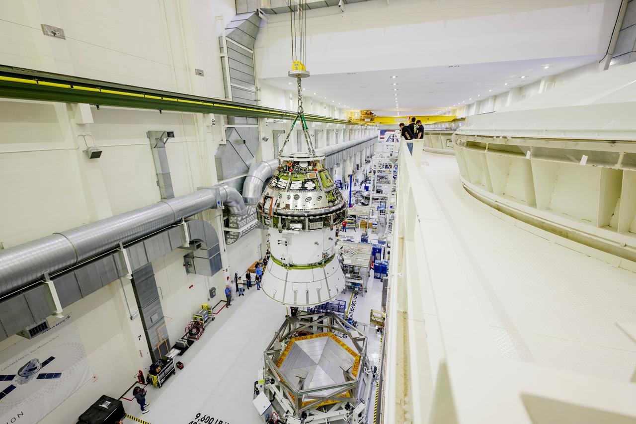 The Artemis II Orion spacecraft is lifted from the Final Assembly and System Testing (FAST) Cell and placed in the west altitude chamber inside the Operations and Checkout Building at NASA’S Kennedy Space Center in Florida on June 28, 2024. Inside the altitude chamber, the spacecraft underwent a series of tests simulating deep space vacuum conditions. Photo Credit: NASA / Rad Sinyak 