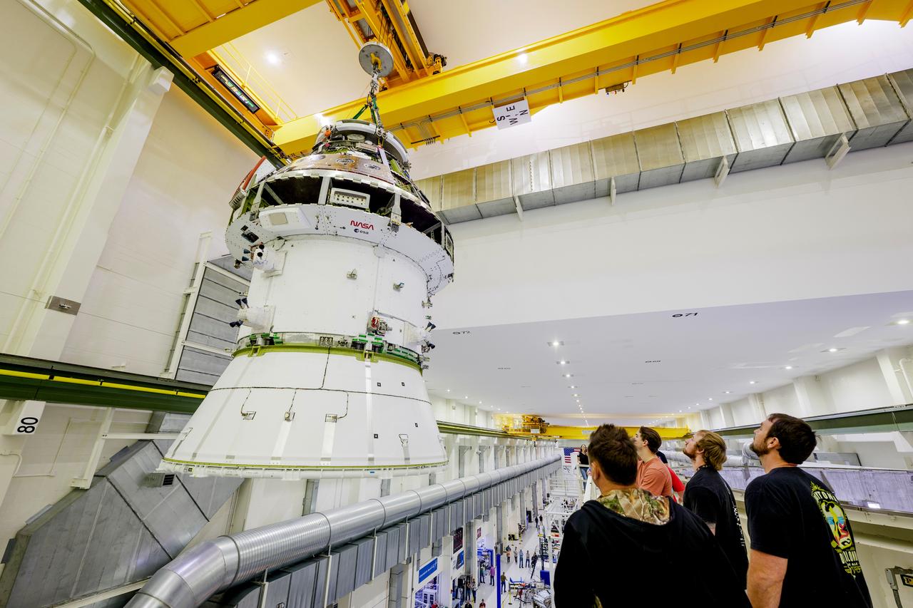 The Artemis II Orion spacecraft is lifted from the Final Assembly and Testing (FAST) Cell and placed in the west altitude chamber inside the Operations and Checkout Building at NASA’S Kennedy Space Center in Florida on June 28, 2024. Inside the altitude chamber, the spacecraft underwent a series of tests simulating deep space vacuum conditions. Photo Credit: NASA / Rad Sinyak 