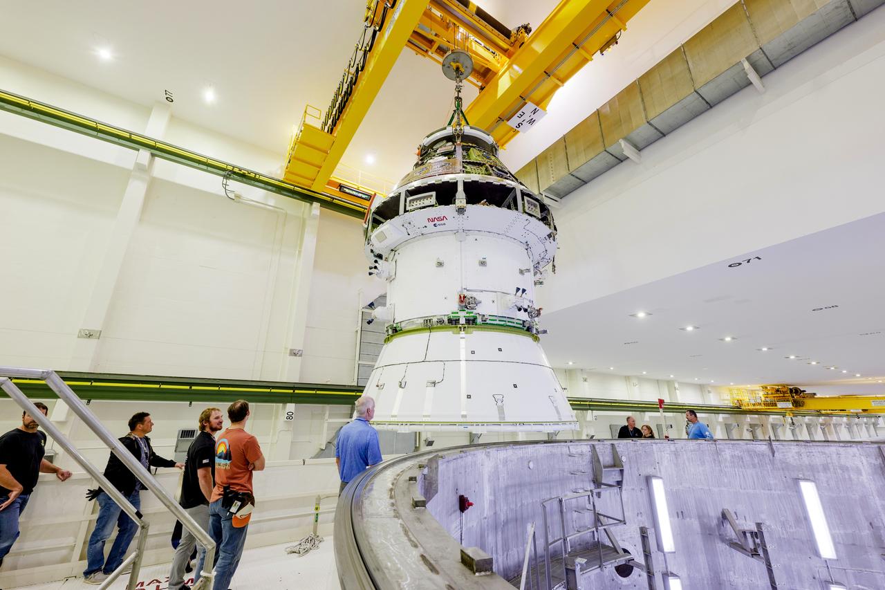 The Artemis II Orion spacecraft is lifted from the Final Assembly and Testing (FAST) Cell and placed in the west altitude chamber inside the Operations and Checkout Building at NASA’S Kennedy Space Center in Florida on June 28, 2024. Inside the altitude chamber, the spacecraft underwent a series of tests simulating deep space vacuum conditions. Photo Credit: NASA / Rad Sinyak 