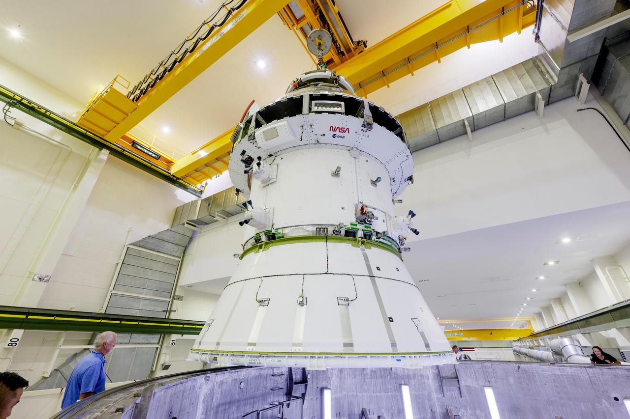 The Artemis II Orion spacecraft is lifted from the Final Assembly and Testing (FAST) Cell and placed in the west altitude chamber inside the Operations and Checkout Building at NASA’S Kennedy Space Center in Florida on June 28, 2024. Inside the altitude chamber, the spacecraft underwent a series of tests simulating deep space vacuum conditions. Photo Credit: NASA / Rad Sinyak 