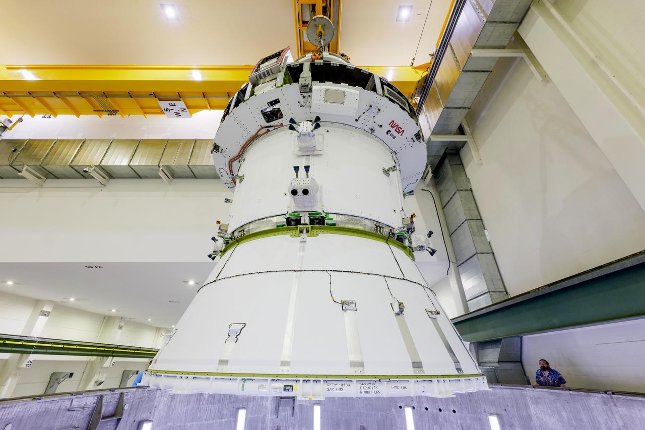 The Artemis II Orion spacecraft is lifted from the Final Assembly and Testing (FAST) Cell and placed in the west altitude chamber inside the Operations and Checkout Building at NASA’S Kennedy Space Center in Florida on June 28, 2024. Inside the altitude chamber, the spacecraft underwent a series of tests simulating deep space vacuum conditions. Photo Credit: NASA / Rad Sinyak 