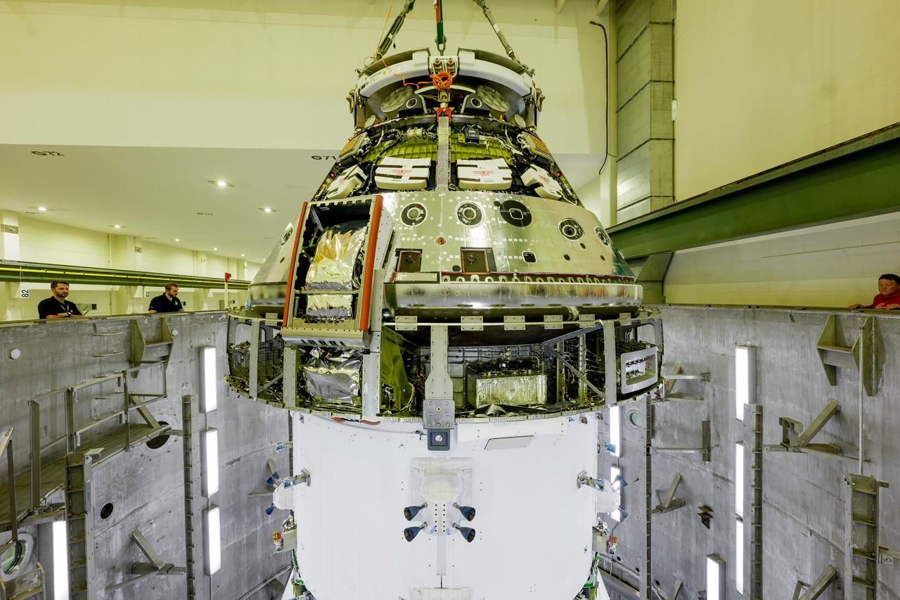 The Artemis II Orion spacecraft is lifted from the Final Assembly and Testing (FAST) Cell and placed in the west altitude chamber inside the Operations and Checkout Building at NASA’S Kennedy Space Center in Florida on June 28, 2024. Inside the altitude chamber, the spacecraft underwent a series of tests simulating deep space vacuum conditions. Photo Credit: NASA / Rad Sinyak 