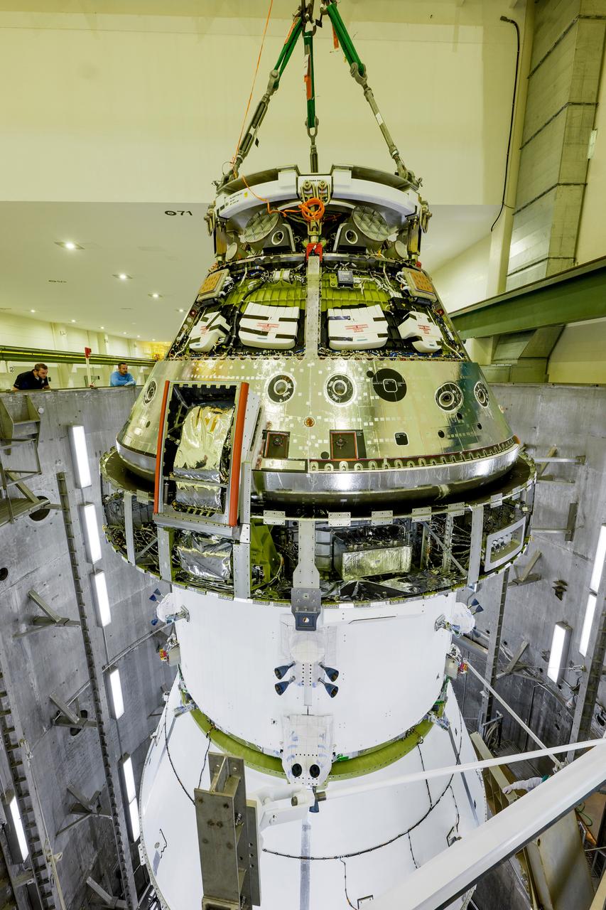 The Artemis II Orion spacecraft is lifted from the Final Assembly and Testing (FAST) Cell and placed in the west altitude chamber inside the Operations and Checkout Building at NASA’S Kennedy Space Center in Florida on June 28, 2024. Inside the altitude chamber, the spacecraft underwent a series of tests simulating deep space vacuum conditions. Photo Credit: NASA / Rad Sinyak 