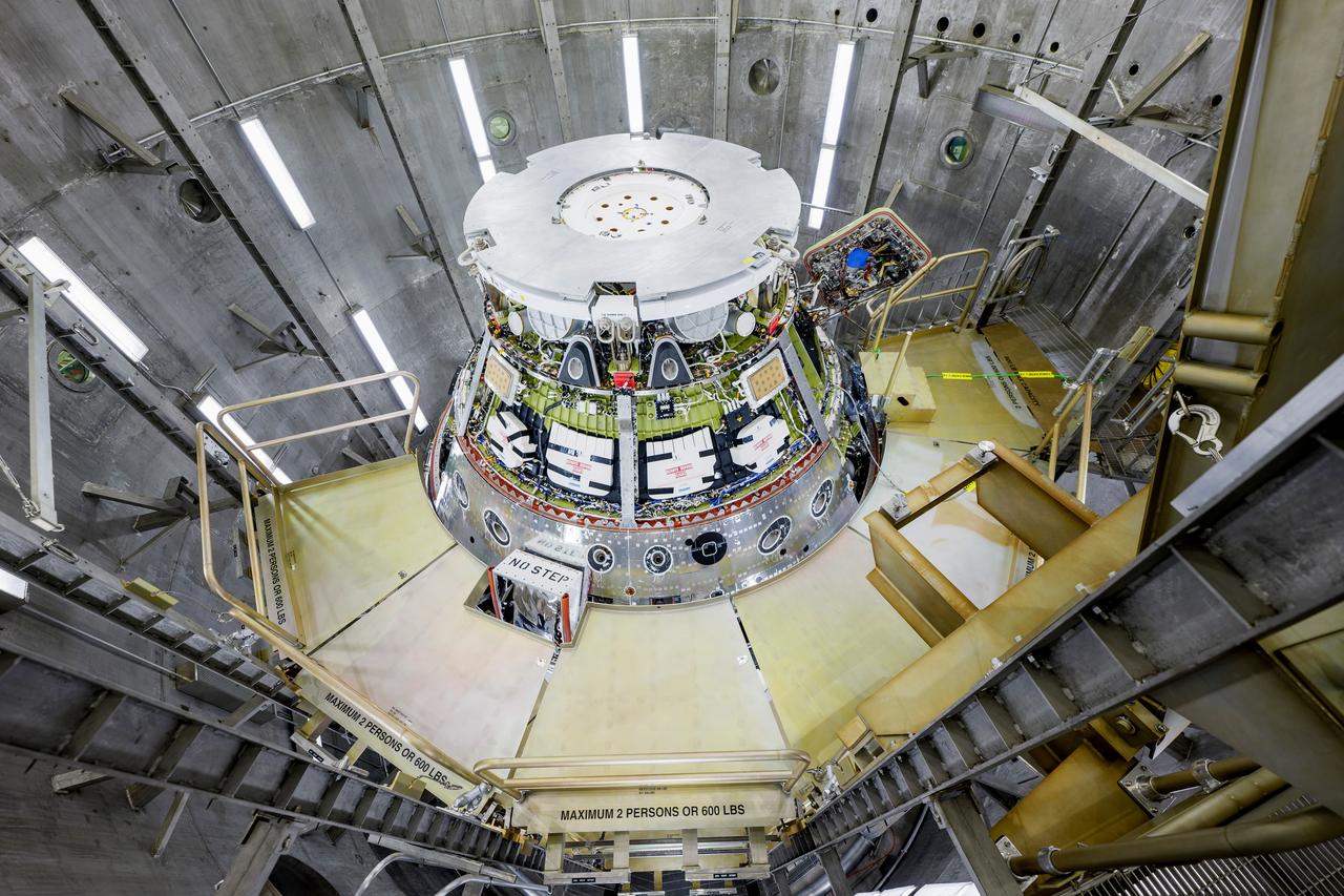 The Artemis II Orion spacecraft is lifted from the Final Assembly and System Testing (FAST) Cell and placed in the west altitude chamber inside the Operations and Checkout Building at NASA’S Kennedy Space Center in Florida on June 28, 2024. Inside the altitude chamber, the spacecraft underwent a series of tests simulating deep space vacuum conditions. Photo Credit: NASA / Rad Sinyak 
