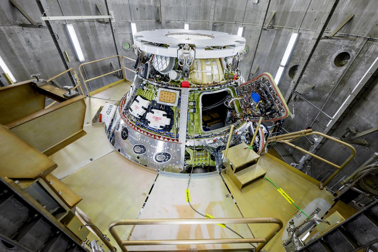 The Artemis II Orion spacecraft is lifted from the Final Assembly and Testing (FAST) Cell and placed in the west altitude chamber inside the Operations and Checkout Building at NASA’S Kennedy Space Center in Florida on June 28, 2024. Inside the altitude chamber, the spacecraft underwent a series of tests simulating deep space vacuum conditions. Photo Credit: NASA / Rad Sinyak 