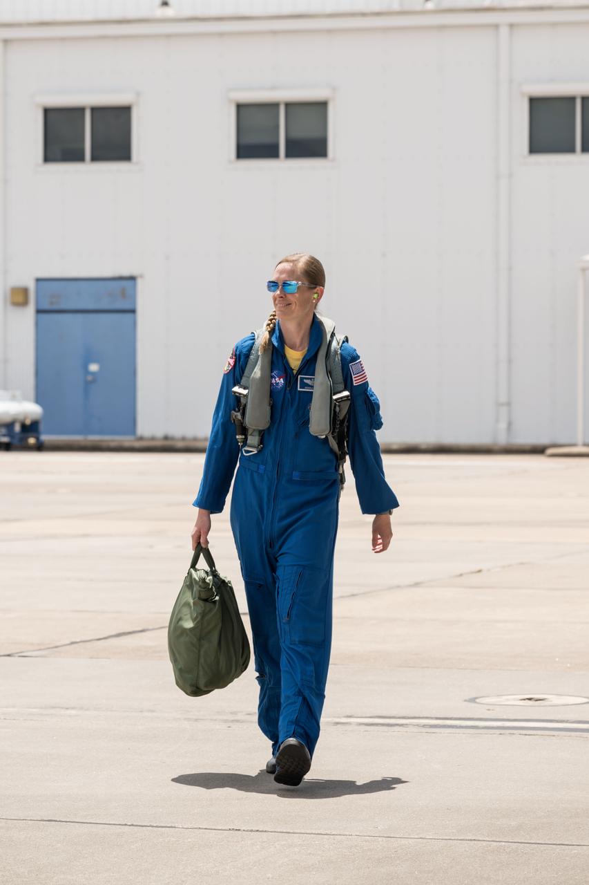 jsc2023e049674 (July 16, 2024) --- NASA astronaut and SpaceX Crew-10 Pilot Nichole Ayers walks on the tarmac toward a T-38 aircraft trainer during pre-flight mission training at Ellington Field in Houston, Texas.