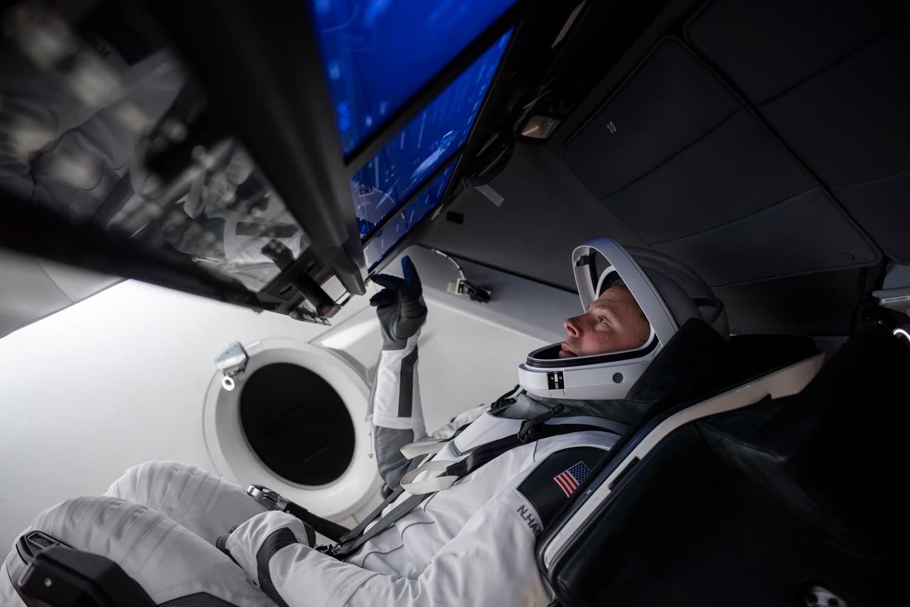 jsc2024e050133 (June 23, 2024) --- NASA’s SpaceX Crew-9 Pilot Nick Hague focuses on his training inside a Dragon mockup crew vehicle at SpaceX headquarters in Hawthorne, California. Credit: SpaceX