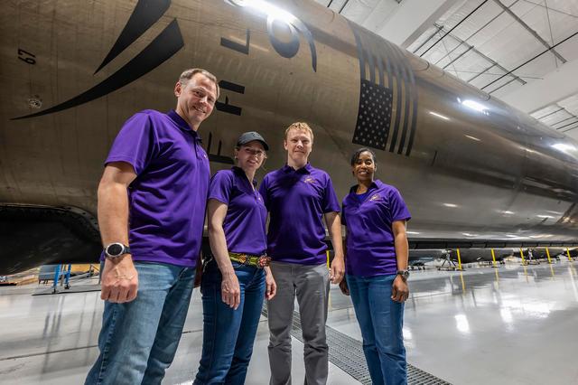 NASA image: NASA’s SpaceX Crew-9 members stand in front of a Falcon 9 first-stage booster