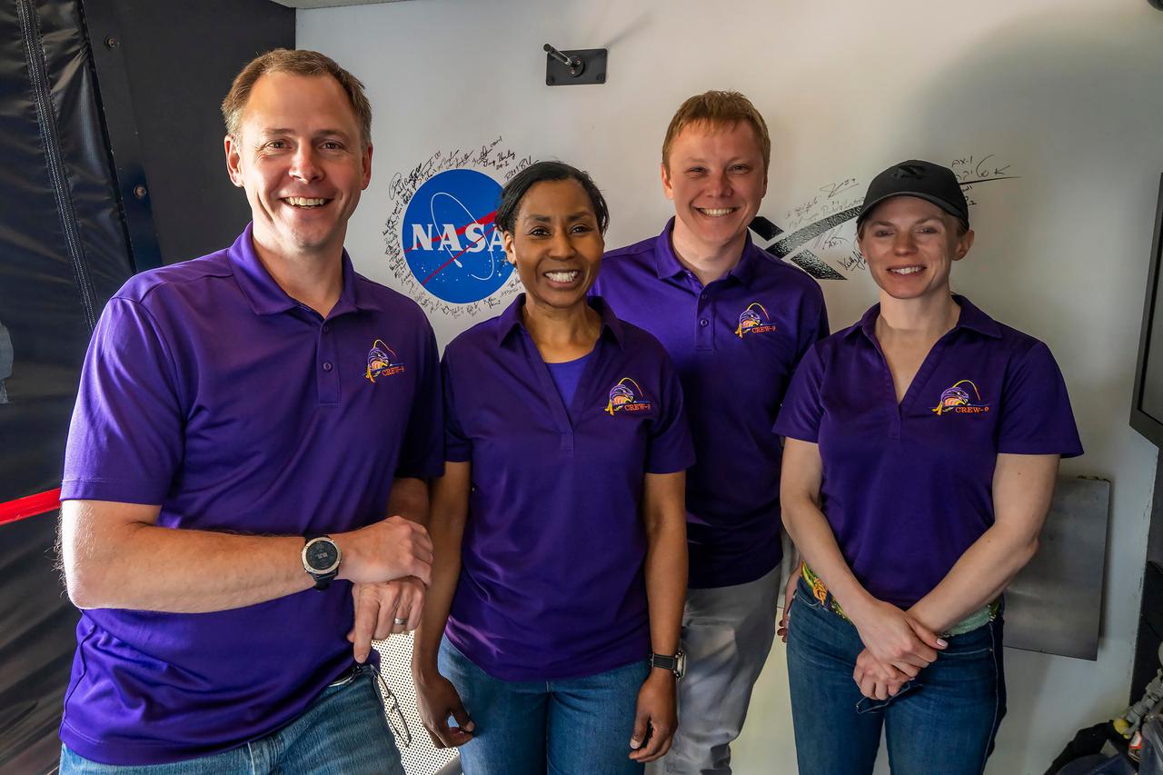jsc2024e050145 (May 13, 2024) --- NASA’s SpaceX Crew-9 members poses for a group photo in front of the White Room located at the end of the crew access arm on the launch tower at Launch Complex 39A at NASA's Kennedy Space Center in Florida. From left are, Pilot Nick Hague from NASA; Mission Specialist Stephanie Wilson from NASA; Mission Spedialist Alexsandr Gorbunov from Roscosmos; and Commander Zena Cardman from NASA. Credit: SpaceX