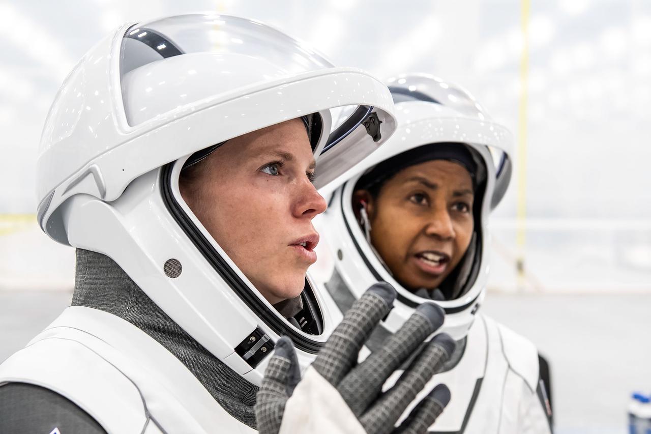 jsc2024e052324 (July 22, 2024) --- NASA’s SpaceX Crew-9 Commander Zena Cardman and Mission Specialist Stephanie Wilson are pictured in their flight suits at SpaceX’s new Dragon refurbishing facility at Kennedy Space Center in Florida. Credit: SpaceX