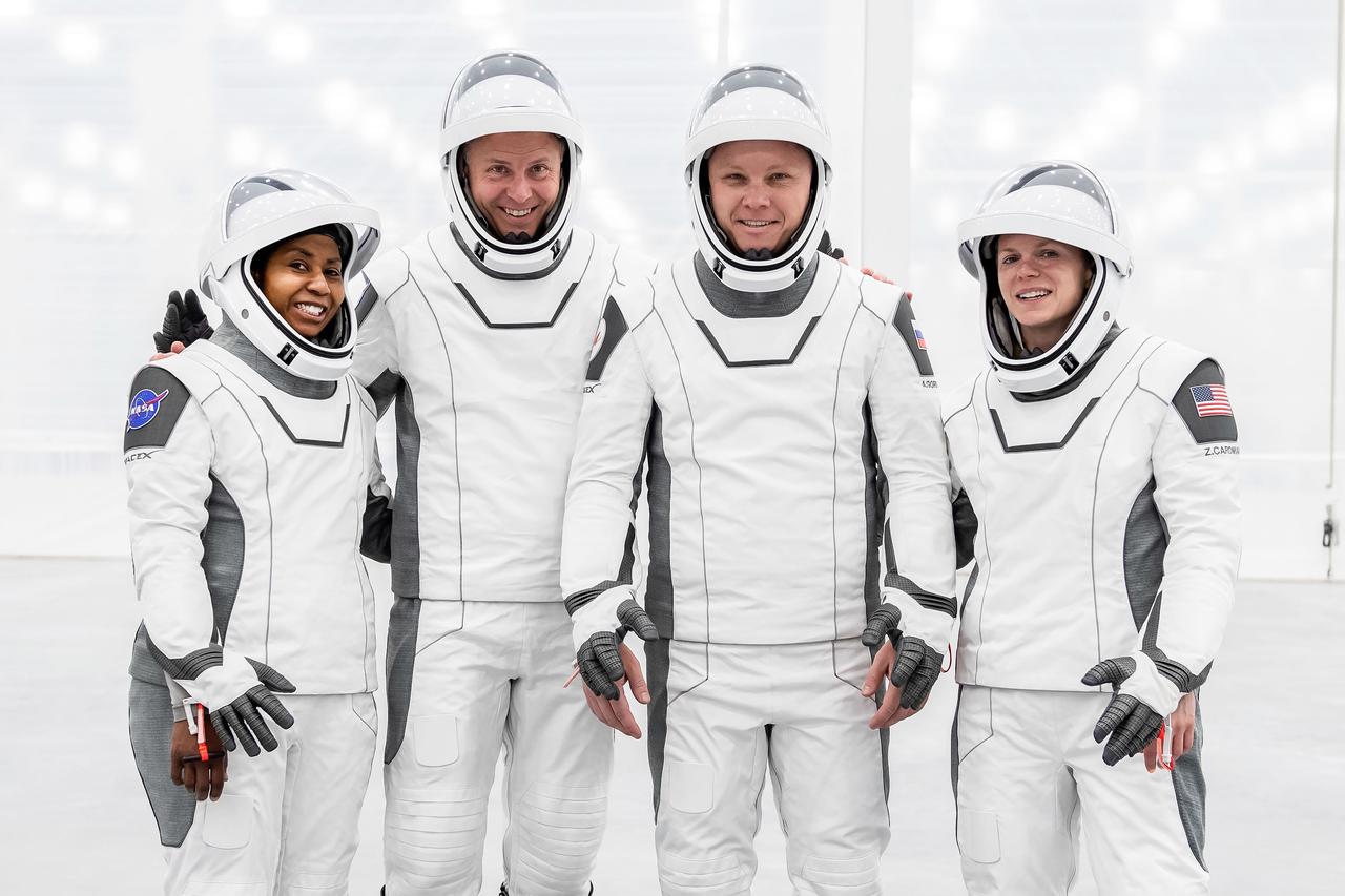 jsc2024e052327 (July 22, 2024) --- The crew of NASA’s SpaceX Crew-9 mission to the International Space Station poses for a group photo in their flight suits at SpaceX’s new Dragon refurbishing facility at Kennedy Space Center in Florida. This will be the first spaceflight for Cardman and Gorbunov, the second mission to the orbiting laboratory for Hague, and fourth spaceflight for Wilson. Credit: SpaceX