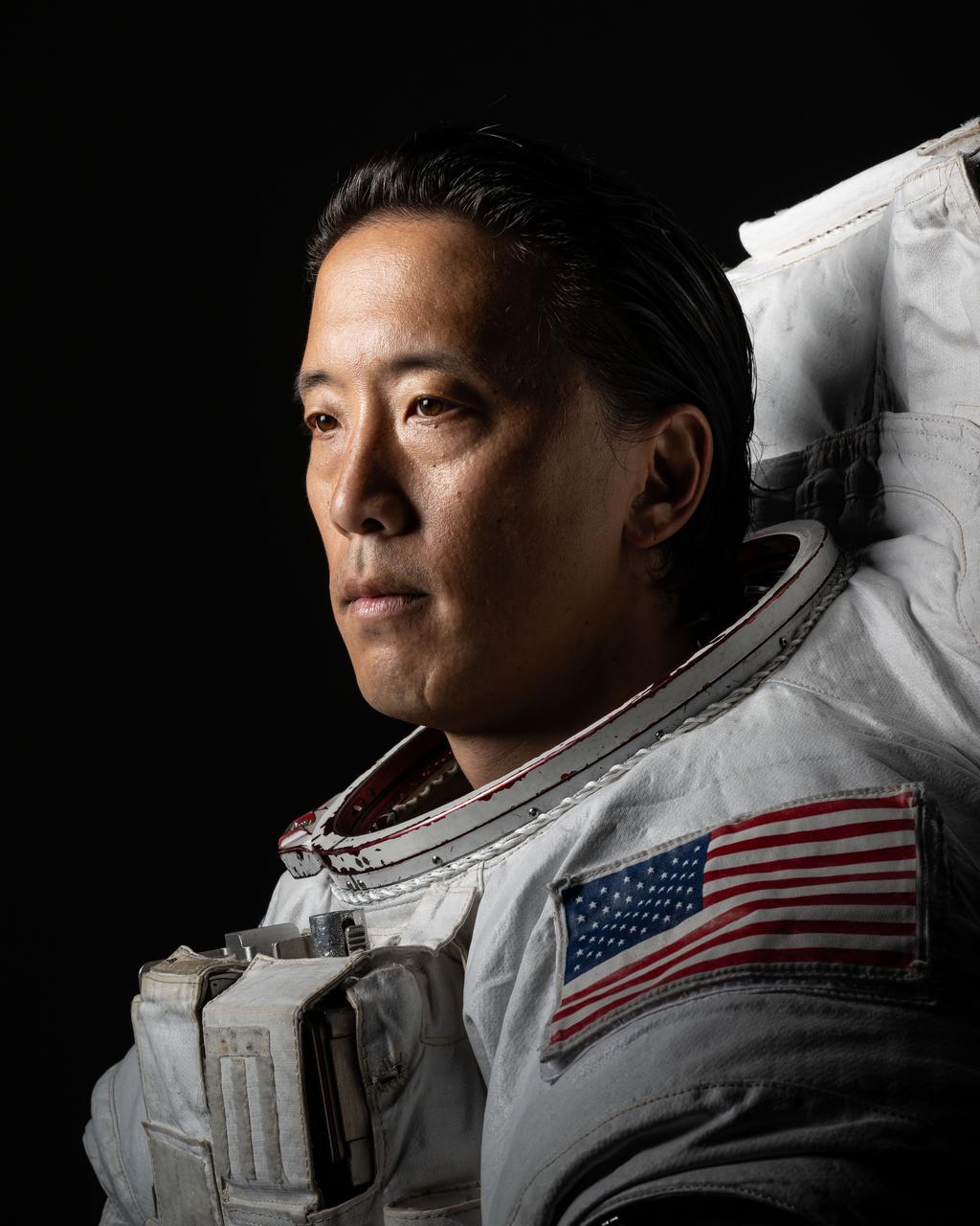 jsc2024e052668_alt (July 17, 2024) --- Portrait of NASA Astronaut Jonny Kim in an Extravehicular Mobility Unit (EMU) spacesuit taken at NASA's Johnson Space Center in Houston, Texas. Credit: NASA/Josh Valcarcel