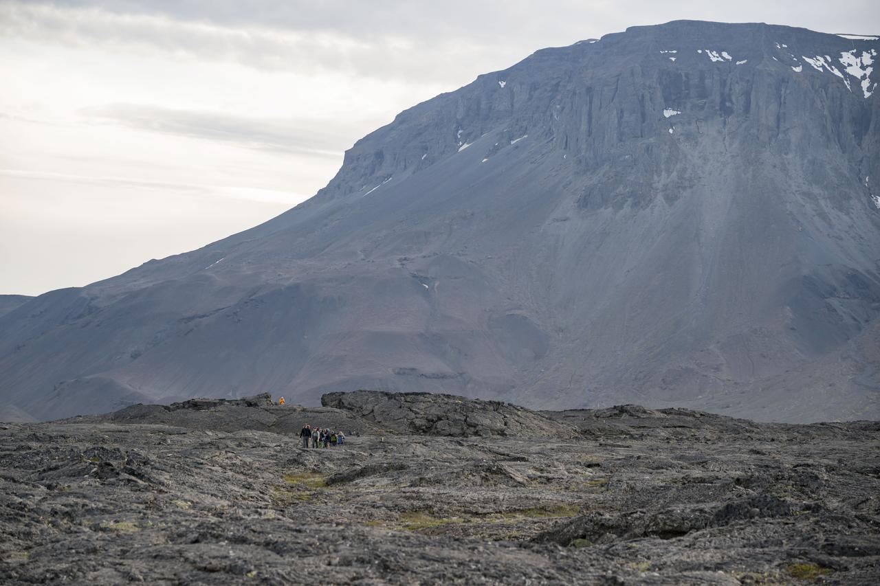 The Artemis II crew, NASA astronauts Reid Wiseman, Victor Glover, Christina Koch, and Canadian Space Agency (CSA) astronaut Jeremy Hansen, and backup crew members NASA astronaut Andre Douglas and CSA astronaut Jenni Gibbons trek across the Icelandic landscape during their field geology training. Credits: NASA/Robert Markowitz 