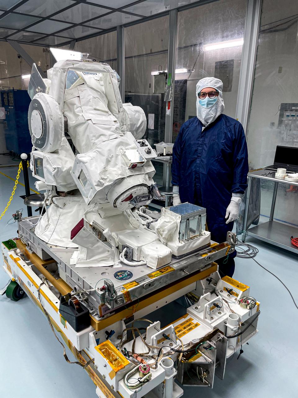 jsc2024e061953 (8/6/2024) --- Jeff Newmark, principal investigator for COronal Diagnostic EXperiment (CODEX), stands with the instrument at the Kennedy Space Flight Center Space Station Processing Facility. CODEX successfully completed all testing at the site and is awaiting integration into the launch vehicle. Credit: CODEX team / NASA