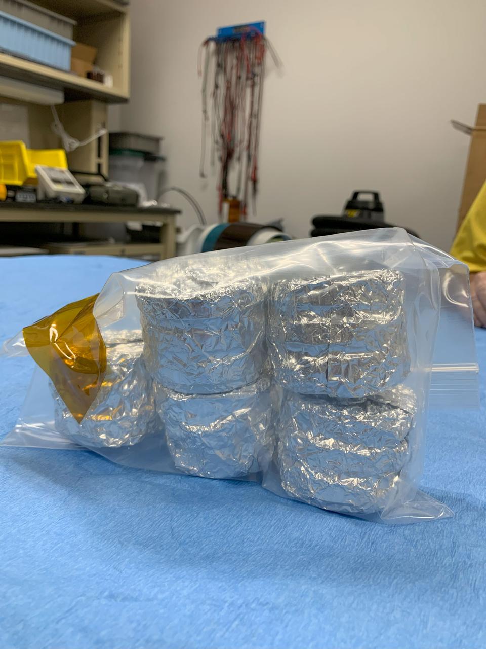 jsc2024e062114 (9/13/2024) --- The ANT1 Radiation Tolerance Experiment with Moss in Orbit on the Space Station (ARTEMOSS) payload: five of the Petri plate stacks are inserted into a flight-approved Zip lock bag and sealed with the zipper seal, a square of the flight-approved Tedlar tape is used for designation of top-bottom orientation relevant for preflight operations and launch. The ARTEMOSS investigation examines whether and how an Antarctic moss repairs damage caused by cosmic radiation and microgravity. Image courtesy of Agata Zupanska.