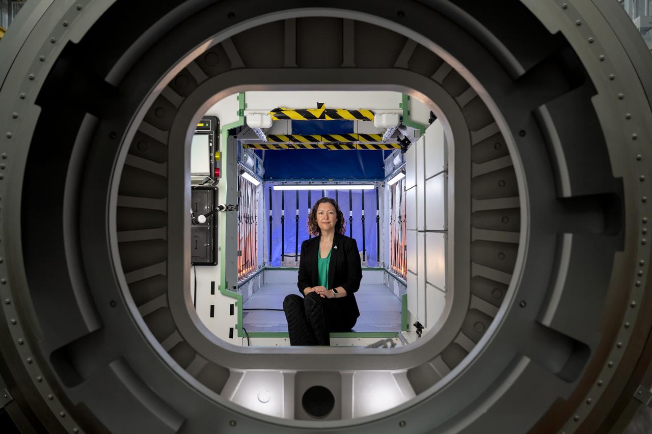 jsc2024e064820 -- Stephanie Dudley, Gateway’s mission integration and utilization manager, sits inside a high-fidelity HALO (Habitation and Logistics Outpost) mockup at NASA’s Johnson Space Center. HALO is one four Gateway modules where astronauts will live, conduct science, and prepare for missions to investigate the lunar South Pole region. Dudley works with NASA’s partner space agencies and academia to identify science opportunities on Gateway.