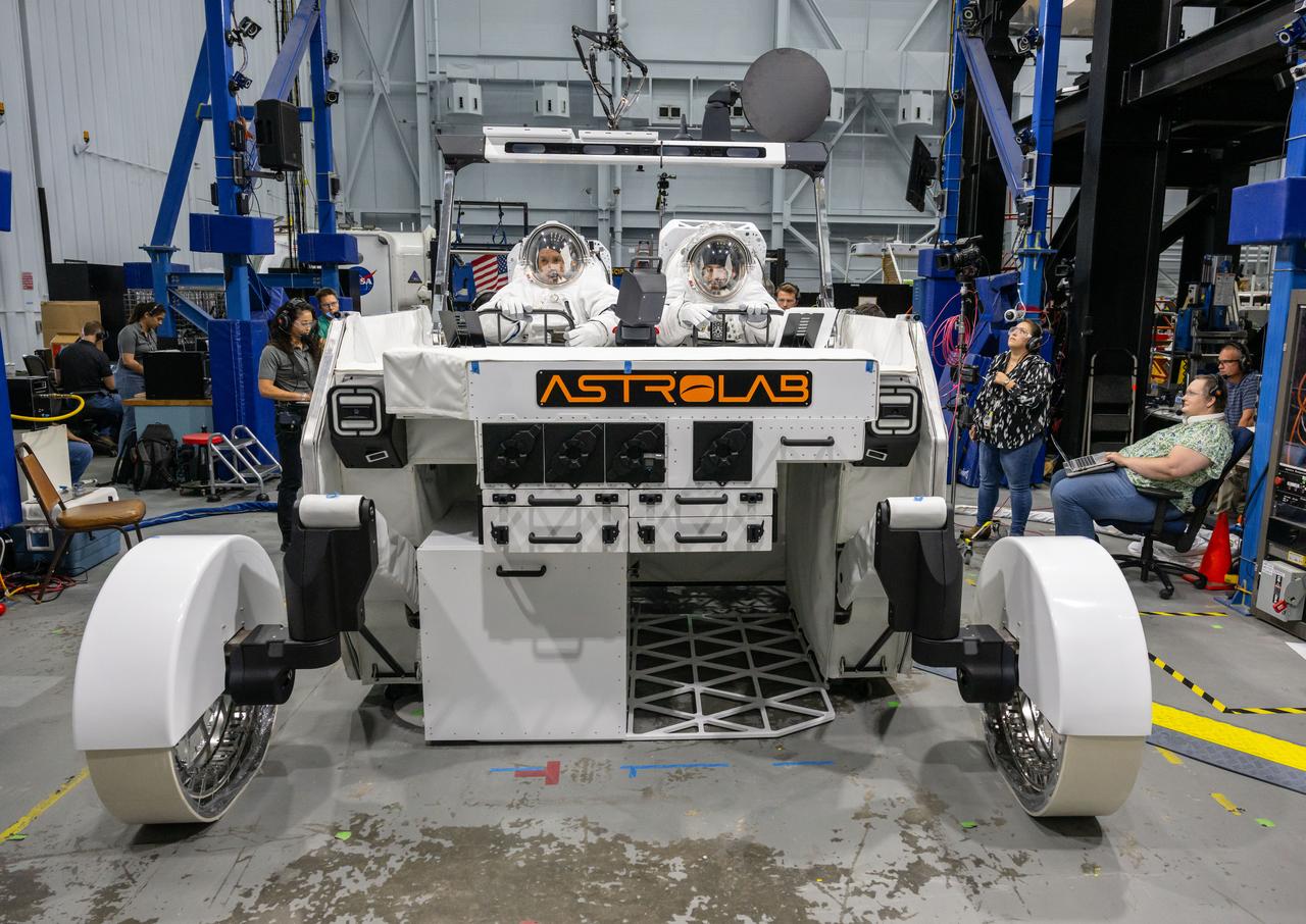 NASA astronaut Frank Rubio (left) and NASA spacesuit engineer Zach Tejral (right) sit inside Astrolab’s FLEX lunar terrain vehicle evaluating the display interfaces during testing at NASA’s Johnson Space Center. Image Credit: NASA/James Blair