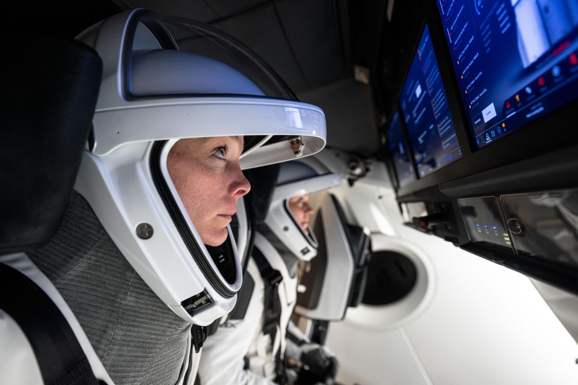 NASA astronaut and pilot of NASA's SpaceX Crew-10 mission Nichole Ayers trains during a simulation inside a mockup of a Dragon cockpit at the company's facilities in Hawthorne, California.
