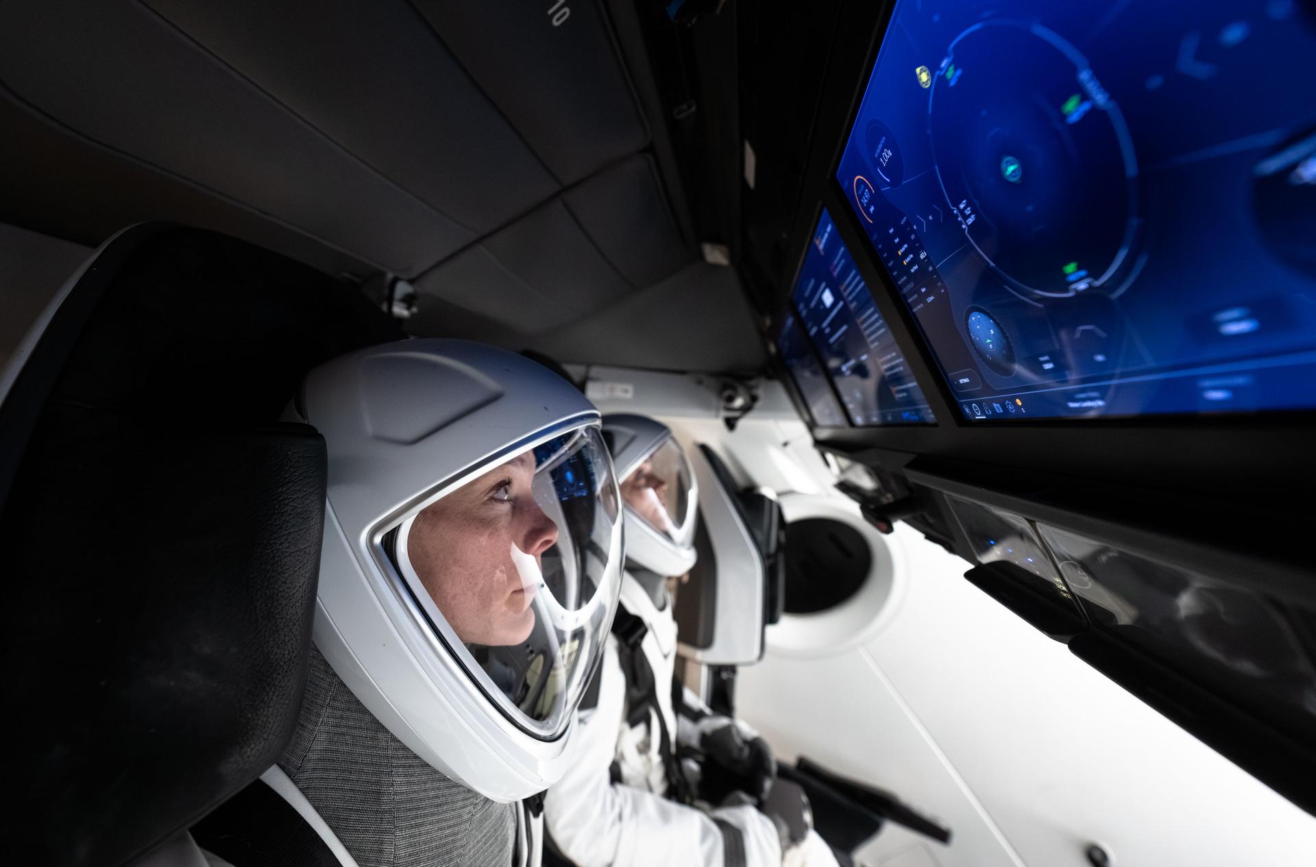 NASA astronaut and pilot of NASA's SpaceX Crew-10 mission Nichole Ayers trains during a simulation inside a mockup of a Dragon cockpit at the company's facilities in Hawthorne, California.