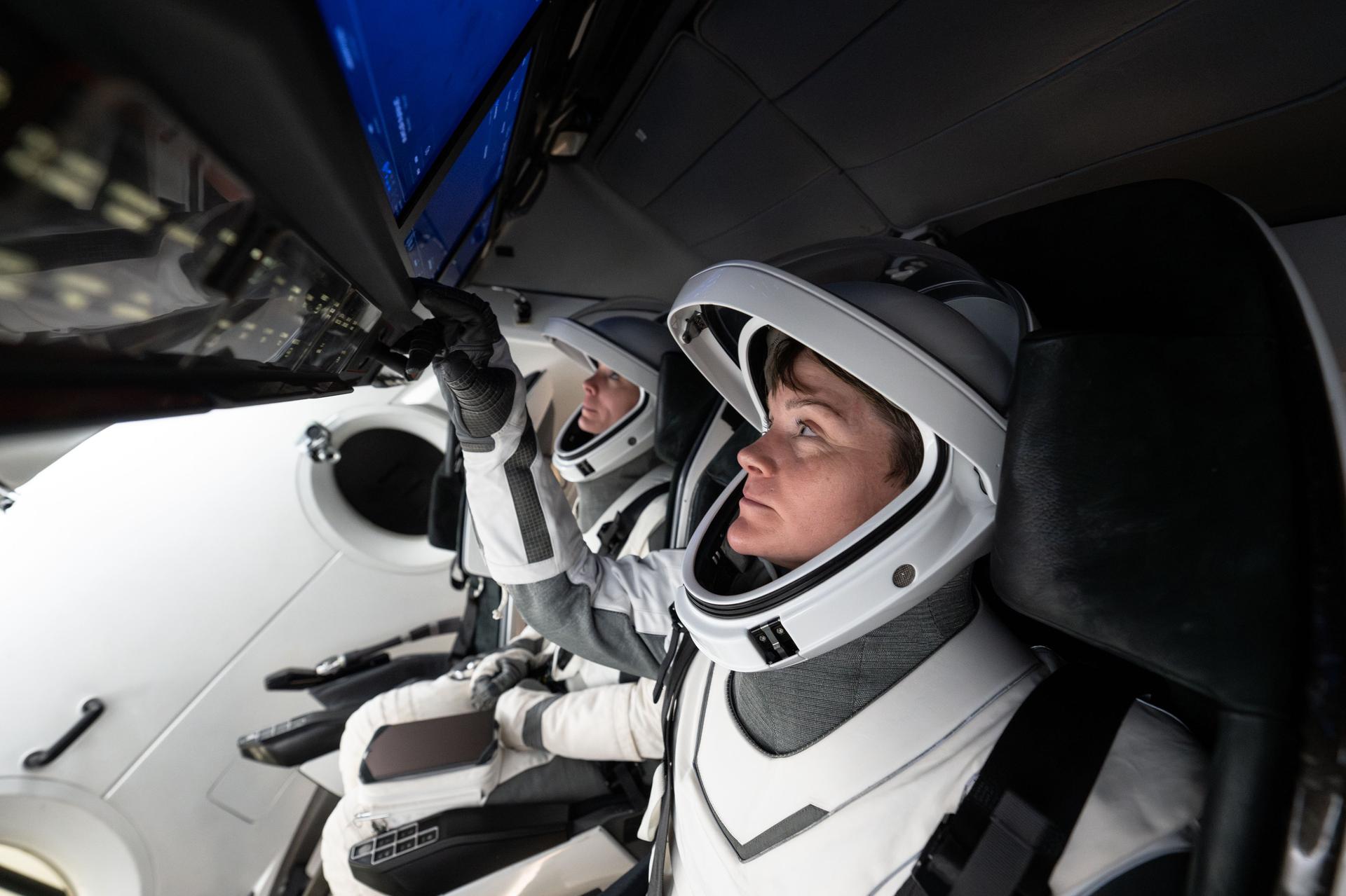 NASA astronaut and commander of NASA's SpaceX Crew-10 mission Anne McClain trains during a simulation inside a mockup of a Dragon cockpit at the company's facilities in Hawthorne, California.