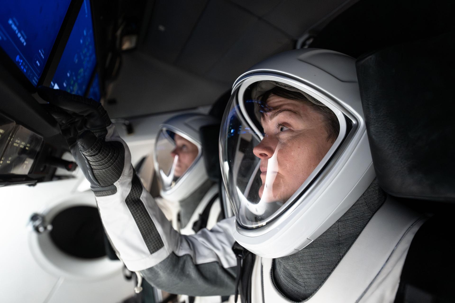 NASA astronaut and commander of NASA's SpaceX Crew-10 mission Anne McClain trains during a simulation inside a mockup of a Dragon cockpit at the company's facilities in Hawthorne, California.