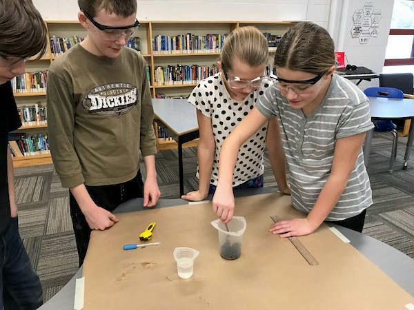 jsc2024e066515 (2/1/2024) --- Alma Public School students remove the sample compostable bag from garden soil following a 10-day period to measure the bag to determine the extent of decomposition. Their experiment, Will Soil Bacteria Biodegrade Compostable Plastic in Microgravity?, is part of the Nanoracks-National Center for Earth and Space Science Education-Surveyor-Student Spaceflight Experiments Program Mission 18 to ISS (Nanoracks-NCESSE-Surveyor-SSEP).