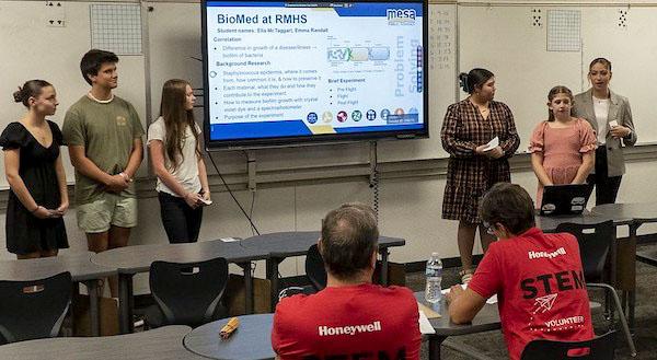 jsc2024e066518 (11/1/2023) --- Mesa Publc School students work together presenting their critical design review to their industry partners Honeywell Aerospace Technologies in their successful bid to be a finalist for the Nanoracks-National Center for Earth and Space Science Education-Surveyor-Student Spaceflight Experiments Program Mission 18 to ISS (Nanoracks-NCESSE-Surveyor-SSEP). Their experiment is The Growth and Mutation of Staphylococcus epidermidis Biofilm in Microgravity.