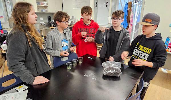 jsc2024e066524 (10/7/2024) --- High Plains School students Maelle Webb, Conor Greene, Aiden Gonzalez, Lee Soyland, and Zachary Collins discuss trial protocols for their experiment, Capsicum annuum Seed Germination in Microgravity. Their experiment is part of the Nanoracks-National Center for Earth and Space Science Education-Surveyor-Student Spaceflight Experiments Program Mission 18 to ISS (Nanoracks-NCESSE-Surveyor-SSEP).