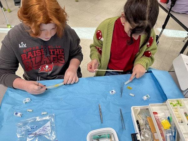 jsc2024e066525 (10/7/2024) --- Seventh grade researchers from Randall Middle School work on optimizing their Taraxacum officinale germination experiment, Handy Dandy Dandelions – Germination of Dandelion in Microgravity, for flight.Their experiment is part of the Nanoracks-National Center for Earth and Space Science Education-Surveyor-Student Spaceflight Experiments Program Mission 18 to ISS (Nanoracks-NCESSE-Surveyor-SSEP).