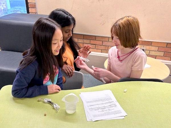 jsc2024e066530 (10/4/2024) --- Creek Valley Elementary School students prepare their experiment, Does Gravity Affect the Germination Growth of Raspberry Seeds, for space. Their experiment is part of the Nanoracks-National Center for Earth and Space Science Education-Surveyor-Student Spaceflight Experiments Program Mission 18 to ISS (Nanoracks-NCESSE-Surveyor-SSEP).
