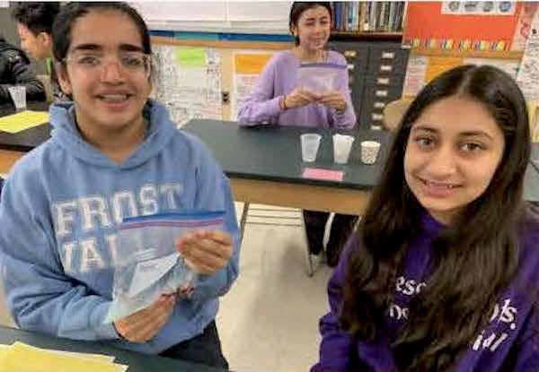 jsc2024e066531 (10/7/2024) --- Garden City Middle School students Anjali P. Motwani and Tanya Oza work on their experiment, The Effects of Microgravity on Salvia hispanica Seeds. Their experiment is part of the Nanoracks-National Center for Earth and Space Science Education-Surveyor-Student Spaceflight Experiments Program Mission 18 to ISS (Nanoracks-NCESSE-Surveyor-SSEP).