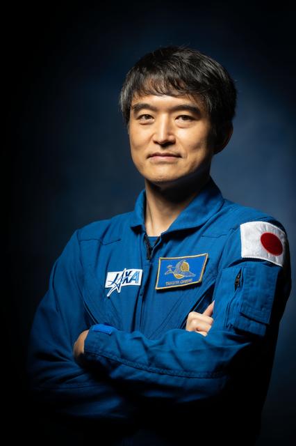 JAXA astronaut Takuya Onishi poses for a crew portrait