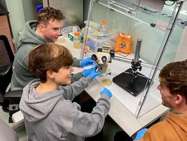 jsc2024e067093 (1/19/2024) --- Ohio University’s Mission 18 Team (Michael Lane, Victoria Swiler and Nathan Smith) examine the growth of Sphingomonas sanguinis, an ISS-derived bacteria. Their experiment, Effect of Spaceflight-Adapted Bacteria on Plant Growth and Resilience in Microgravity, is part of the Nanoracks-National Center for Earth and Space Science Education-Surveyor-Student Spaceflight Experiments Program Mission 18 to ISS (Nanoracks-NCESSE-Surveyor-SSEP).