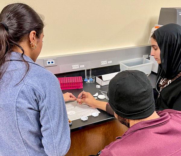 jsc2024e067100 (1/22/2024) --- The San Jacinto College – South Campus student team prepares a trial run to optimize germination conditions for their experiment, Comparison of Arabidopsis thaliana Germination and Cell Wall Growth in Microgravity versus Standard Conditions. Their experiment is part of the Nanoracks-National Center for Earth and Space Science Education-Surveyor-Student Spaceflight Experiments Program Mission 18 to ISS (Nanoracks-NCESSE-Surveyor-SSEP).