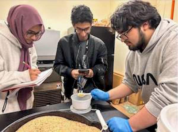 jsc2024e067101 (10/15/2024) --- Plano ISD Academy High School students Nawal, Abhi, and Jacob measure feed for the crickets they are farming. They need to harvest the eggs for their experiment, Growth and Life Cycle of Crickets (Acheta domesticus) in Microgravity for Astronaut Consumption. Their experiment is part of the Nanoracks-National Center for Earth and Space Science Education-Surveyor-Student Spaceflight Experiments Program Mission 18 to ISS (Nanoracks-NCESSE-Surveyor-SSEP).