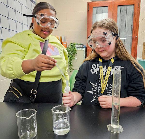jsc2024e067105 (1/29/2024) --- Eddie Finley Junior High School student researchers (Caris Gray and Olivia Jones) adding tardigrade to the experiment tube to begin terrestrial examination of tardigrade growth. Their experiment, Tardigrade Growth in Space, is part of the Nanoracks-National Center for Earth and Space Science Education-Surveyor-Student Spaceflight Experiments Program Mission 18 to ISS (Nanoracks-NCESSE-Surveyor-SSEP).