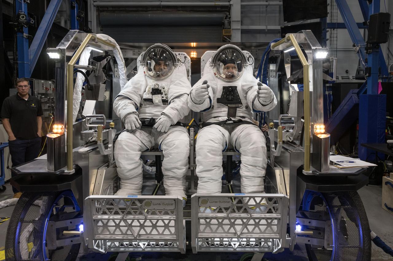 NASA astronauts Raja Chari (left) and Randy Bresnik (right) sit inside Lunar Outpost’s Eagle lunar terrain vehicle evaluating the seat configuration during testing at NASA’s Johnson Space Center. Image Credit: NASA/David DeHoyos