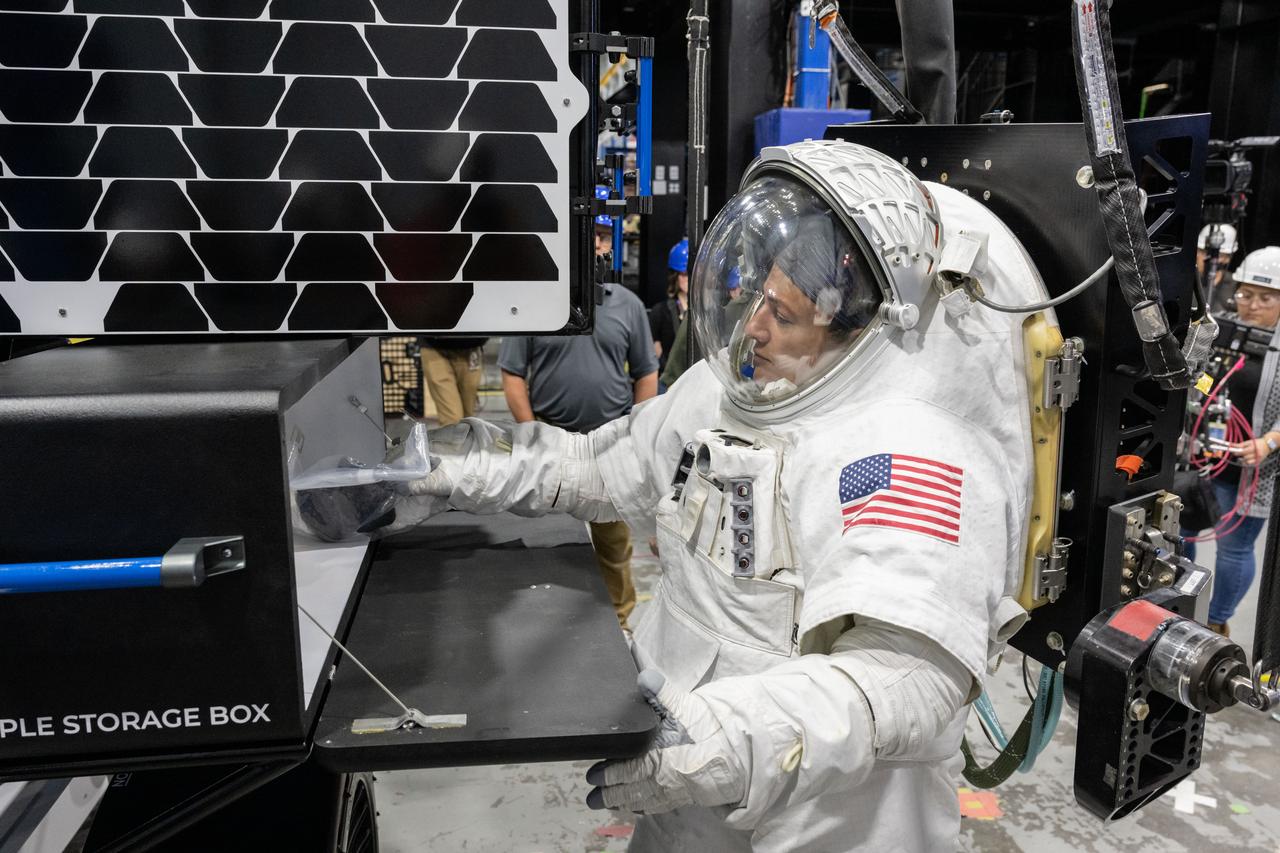 NASA astronaut Jessica Meir puts a science sample inside of a storage box on Intuitive Machines’ Moon RACER lunar terrain vehicle during testing at NASA’s Johnson Space Center. Image Credit: NASA/James Blair