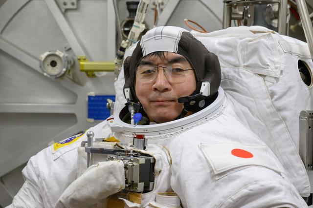 NASA image: JAXA astronaut Kimiya Yui poses for a photo in his spacesuit 