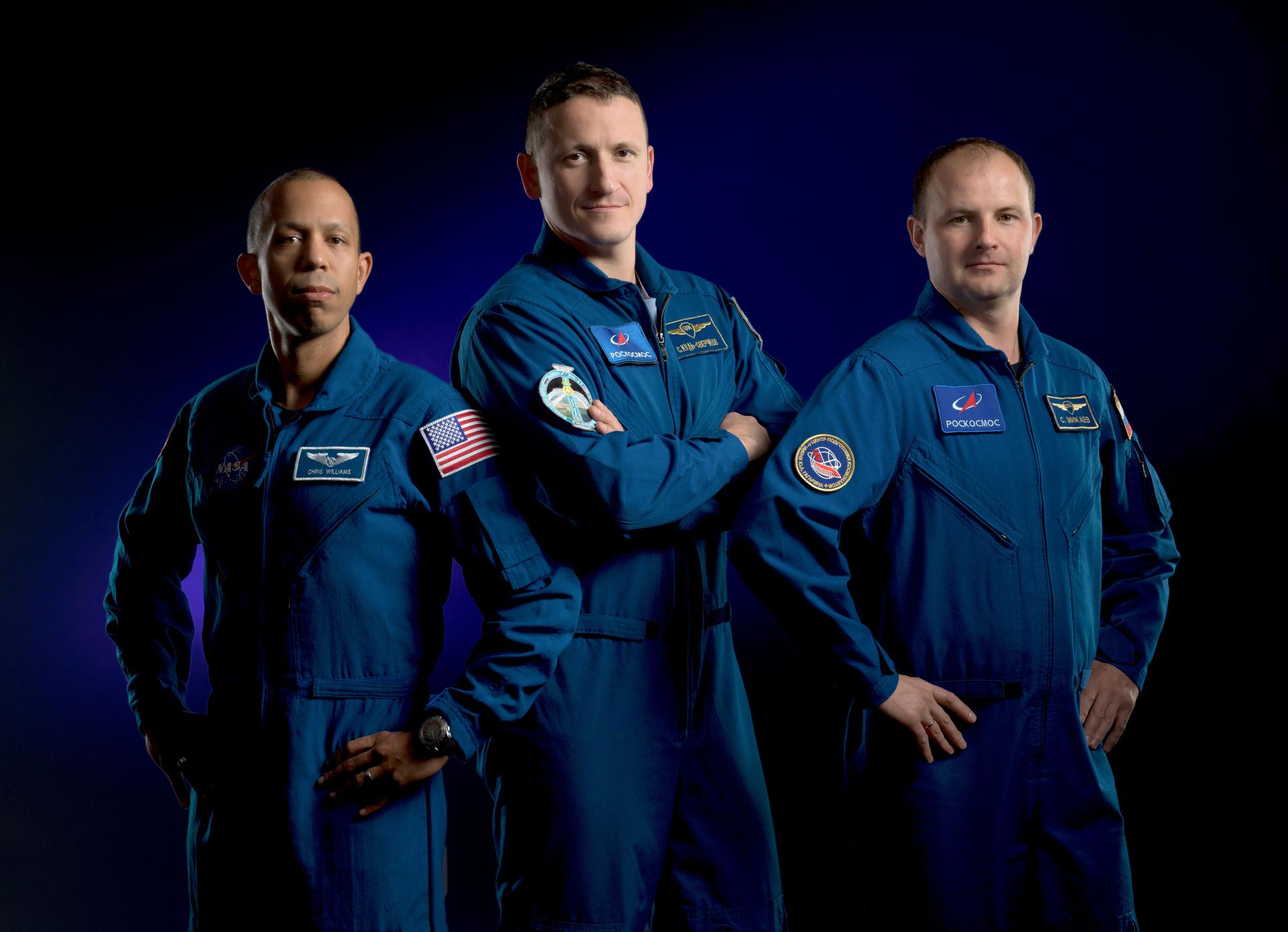 Expedition 74 crew members (from left) NASA astronaut Chris Williams and Roscosmos cosmonauts Sergey Kud-Sverchkov and Sergey Mikaev pose for a portrait at NASA's Johnson Space Center in Houston, Texas.