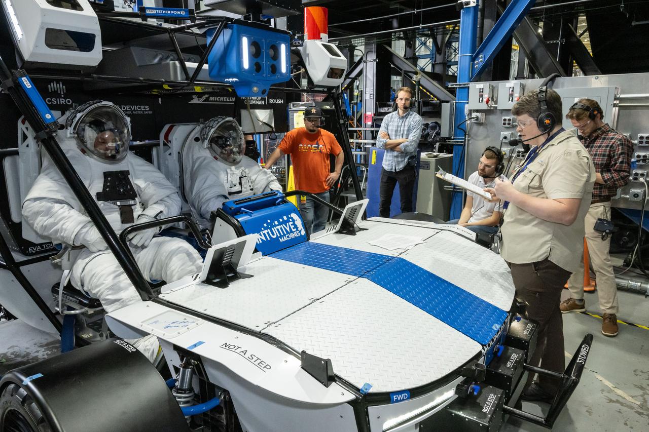 NASA engineer Dave Coan (left) and NASA astronaut Jessica Watkins (right) sit inside Intuitive Machines’ Moon RACER lunar terrain vehicle evaluating the crew compartment during testing at NASA’s Johnson Space Center. Image Credit: NASA/James Blair
