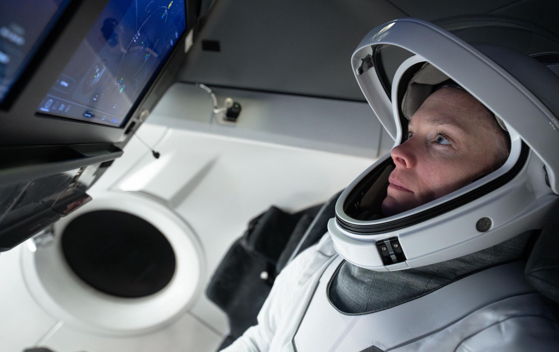 NASA astronaut and Pilot for NASA’s SpaceX Crew-10 mission Nichole Ayers is pictured training inside a mockup of a Dragon cockpit at the company's facilities in Hawthorne, California