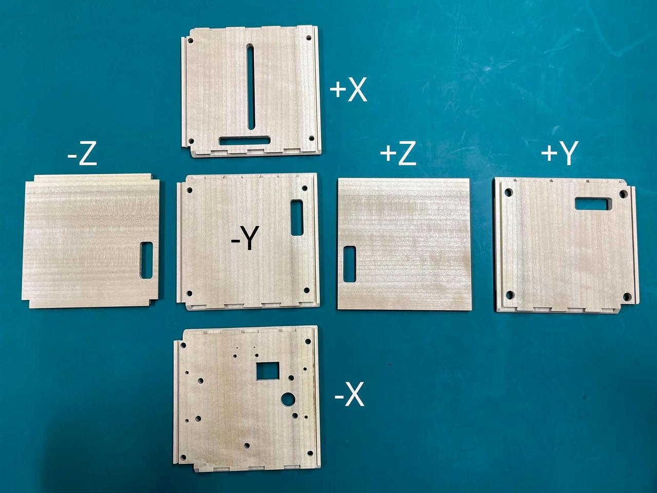 jsc2024e081747 (12/17/2024) --- Six wooden panels of the LignoSat are shown with their coordinate marks. LignoSat is the world’s first wooden satellite to demonstrate whether wood can be used in space and is deployed as part of the JEM Small Satellite Orbital Deployer-30 (J-SSOD-30) CubeSat deployment mission. Image courtesy of Kyoto University.