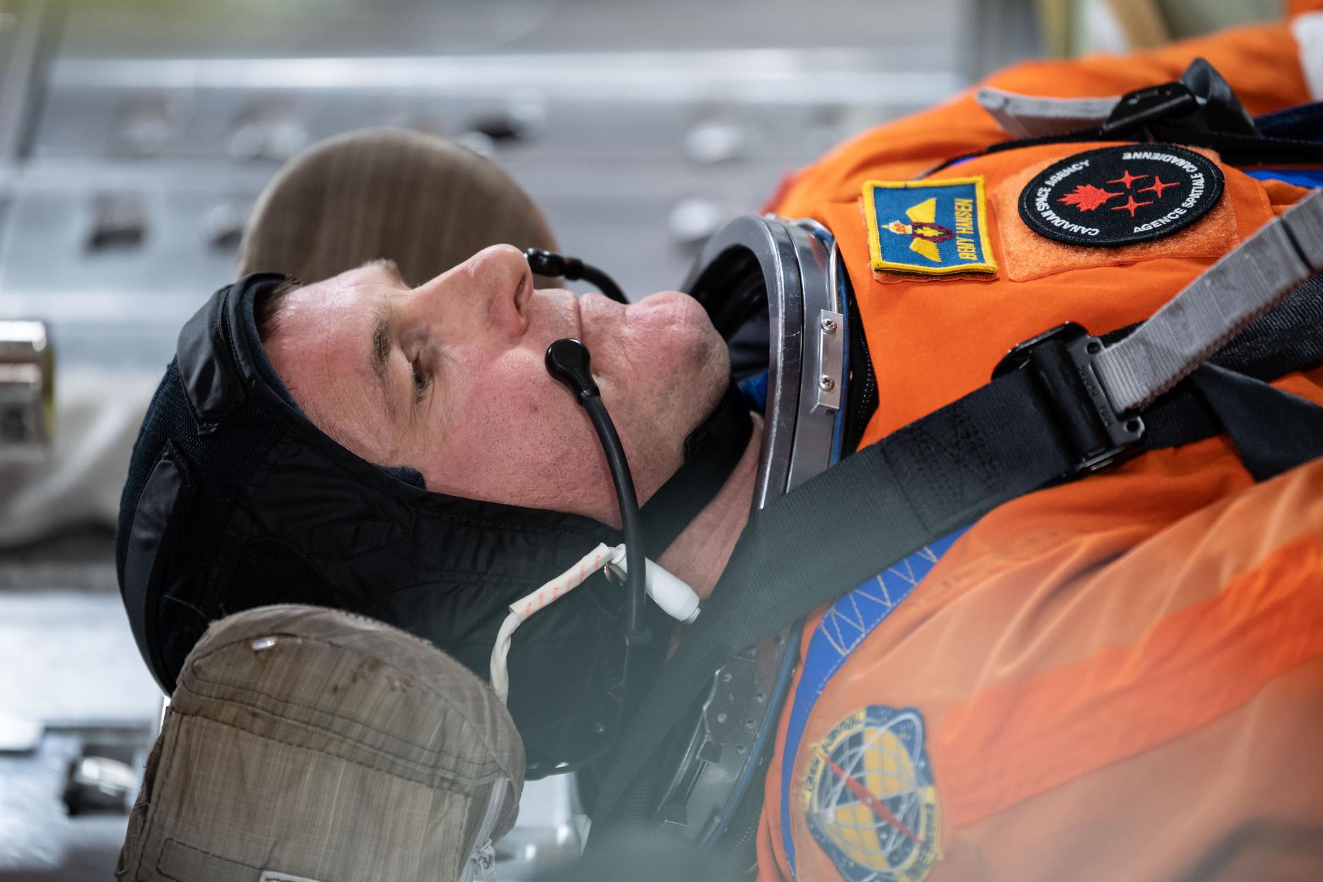 Canadian Space Agency astronaut and Artemis II mission specialist Jeremy Hansen inside of the Orion spacecraft mockup during Post Insertion and Deorbit Preparation training at the Space Vehicle Mockup Facility in Houston, Texas. The crew practiced getting the Orion spacecraft configured once in orbit, how to make it habitable, and suited up in their entry pressure suits to prepare for their return from the Moon